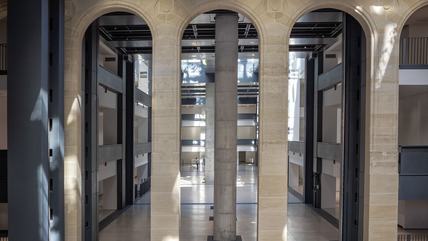 Grand stone arcades opening into the multi-level nave of the new Fondation Cartier in Paris